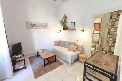 a living room with a couch and a table at 1 bedroom apartment near the beach in Ajaccio
