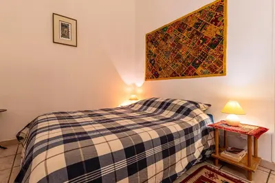 a bedroom with a bed and two lamps on tables at Appartement cosy - Hyper centre-ville in Ajaccio