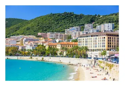 a beach with people on the sand and a city at Appartement cosy - Hyper centre-ville in Ajaccio