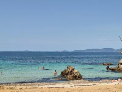 a group of people in the water at a beach at Appartement Neuf Grande Terrasse AGOSTA PLAGE in Albitreccia