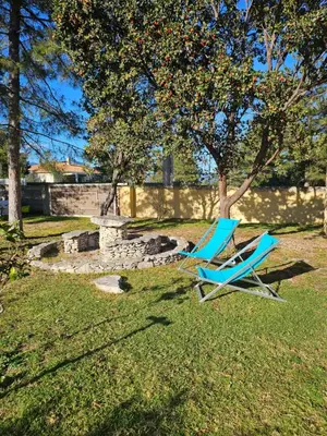 two blue lawn chairs sitting in the grass at Studio Villa Boca in Prunelli-di-Fiumorbo