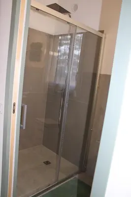a glass shower in the corner of a room at Studio Villa Boca in Prunelli-di-Fiumorbo