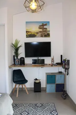 a desk with a monitor and a chair in a room at Studio Villa Boca in Prunelli-di-Fiumorbo