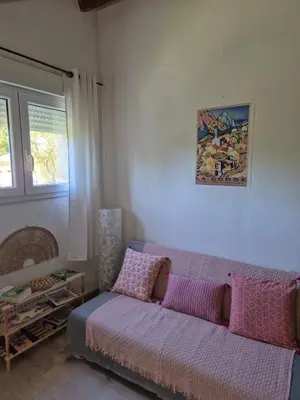 a living room with a couch and a window at Appartement calme & cosy vue montagne in Corte