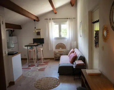 a living room with a couch and a window at Appartement calme & cosy vue montagne in Corte