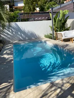 a pool with blue water in a backyard at Casa Di Lortu villa in Ajaccio