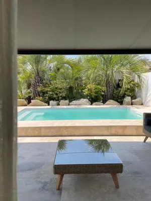 a view of a swimming pool with a bench and a table at Casa Di Lortu villa in Ajaccio