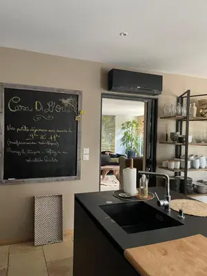 a kitchen with a black counter and a chalkboard on the wall at Casa Di Lortu villa in Ajaccio