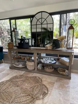 a room with a table with a mirror and a rug at Casa Di Lortu villa in Ajaccio
