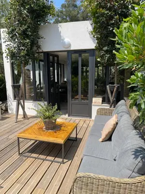 a couch on a deck with a coffee table at Casa Di Lortu villa in Ajaccio