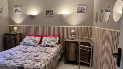 a bedroom with a bed with red pillows at villa vue mer avec piscine et jardin arboré in Coggia