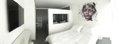 a bedroom with a bed with a painting on the wall at Villa Isulana, piscine chauffée, vue mer, proche Pinarello in Zonza