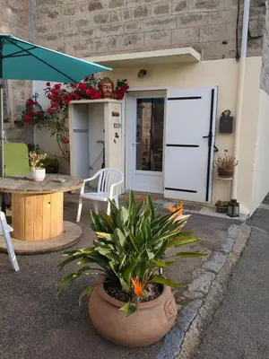 a living room with a red couch and a table at Casa Di mamou in Loreto-di-Tallano