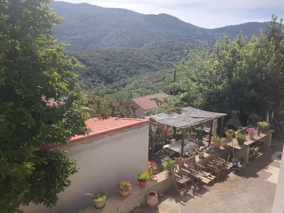 a white table with green plates on top of it at Casa Di mamou in Loreto-di-Tallano