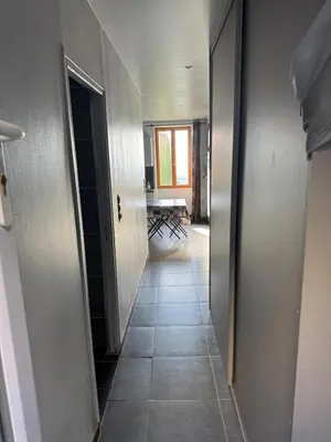 an empty hallway with a hallway leading to a room at Studio in Sartène