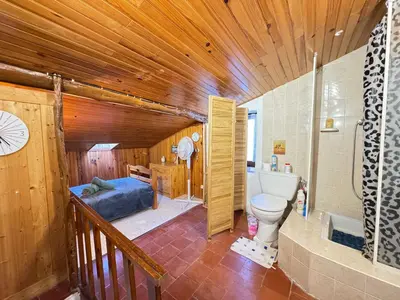 a bathroom with a bed and a toilet in a room at L'Alcôve - Wifi, TV, Central in Bonifacio