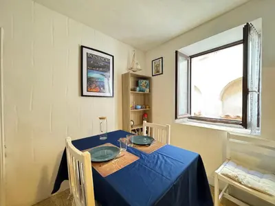 a blue table with two plates on it in a room at L'Alcôve - Wifi, TV, Central in Bonifacio