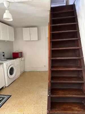 a staircase in a kitchen with a washing machine at L'Alcôve - Wifi, TV, Central in Bonifacio