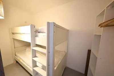a closet with two bunk beds in a room at U Mare - T2 cabine avec vue mer, plage & piscine in Pianottoli-Caldarello