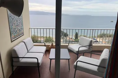 a balcony with chairs and a view of the ocean at Maria - 3BR Terrace Panoramic sea view - by TGB in Ajaccio