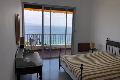 a bedroom with a bed and a view of the ocean at Maria - 3BR Terrace Panoramic sea view - by TGB in Ajaccio