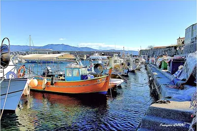 an orange boat is docked in a harbor at Maria - 3BR Terrace Panoramic sea view - by TGB in Ajaccio