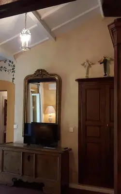 a room with a mirror and a tv on a dresser at L'Olettese in Oletta