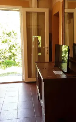 a living room with a mirror and a tv at L'Olettese in Oletta
