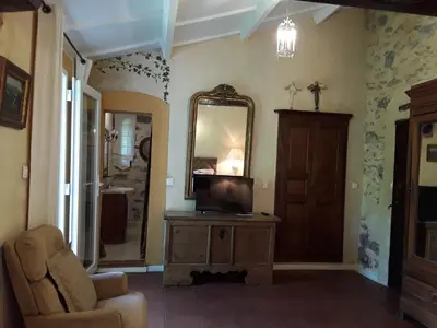 a bedroom with a bed and a lamp and a chair at L'Olettese in Oletta