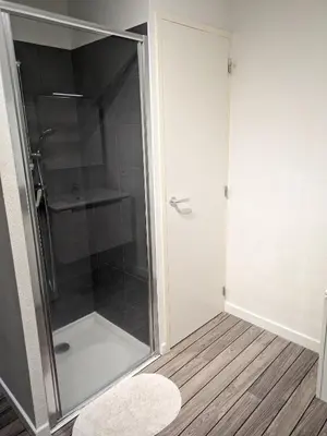 a shower with a glass door in a bathroom at Joli cocon à Ajaccio avec terrasse vue mer in Ajaccio