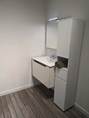 a white bathroom with a sink and a mirror at Joli cocon à Ajaccio avec terrasse vue mer in Ajaccio
