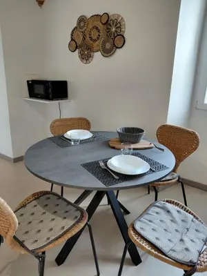 a black table with chairs and plates on it at U Casone in Aléria