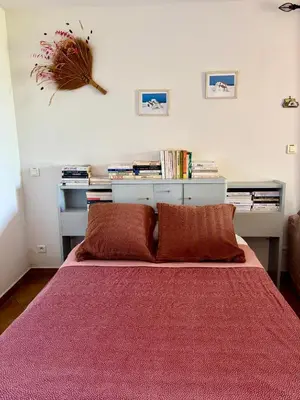 a bedroom with a bed with a red blanket at Grand appartement vue mer Agosta in Albitreccia
