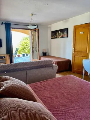 a living room with a couch and a bed at Grand appartement vue mer Agosta in Albitreccia