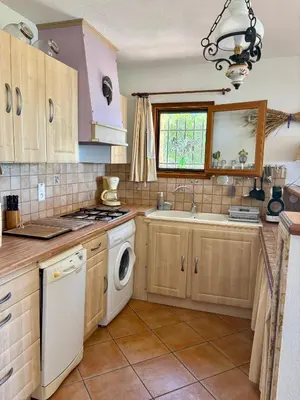 a kitchen with a washer and dryer at Grand appartement vue mer Agosta in Albitreccia