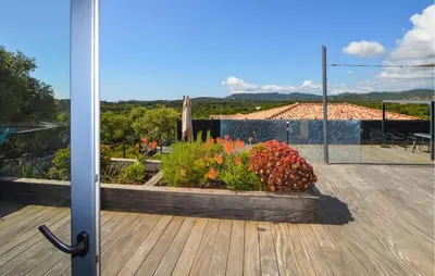 a view of a balcony with a garden with flowers at Villa Spacieuse Proche Plages in Vardiola