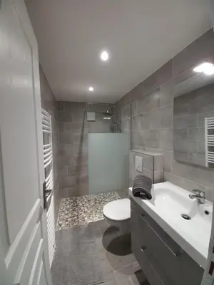 a bathroom with a toilet and a sink and a tub at Les voûtes de Pascaline, vue mer et montagne, Lama in Lama