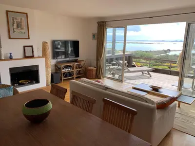 a living room with a couch and a table at Bonifacio accès mer et golf - vue exceptionnelle in Bonifacio