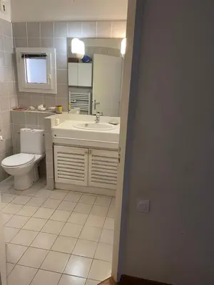 a bathroom with a sink and a toilet and a mirror at Bonifacio accès mer et golf - vue exceptionnelle in Bonifacio