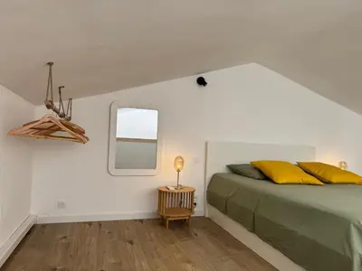 a bedroom with a bed with yellow pillows and a window at Villa Porto Vecchio, calme avec piscine in Porto-Vecchio