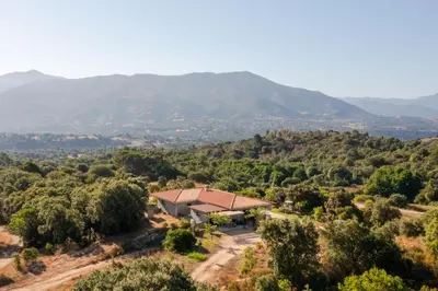 an aerial view of a house in the mountains at Gozzi Mandriolu in Afa