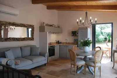 a kitchen and living room with a couch and a table at Villa Madra in Bonifacio