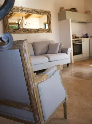 a living room with a couch and a mirror at Villa Madra in Bonifacio