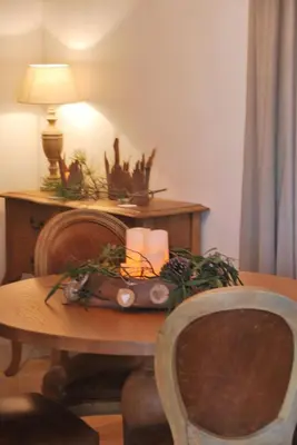 a room with a table with a candle and a lamp at Villa Madra in Bonifacio