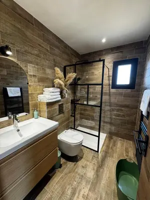 a bathroom with a sink and a toilet and a television at casanova in Bonifacio