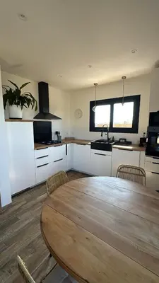 a kitchen with a large wooden table in a room at casanova in Bonifacio