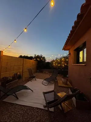 a patio with chairs and lights at night at casanova in Bonifacio