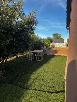 a table and chairs sitting on a lawn at casanova in Bonifacio