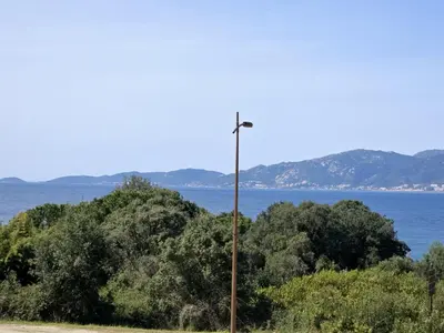 a street light in front of a body of water at appartement T2 rive sud porticcio vue mer in Pietrosella