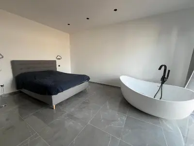 a bedroom with a tub and a bed and a bed at Maison 2 chambres in Figari
